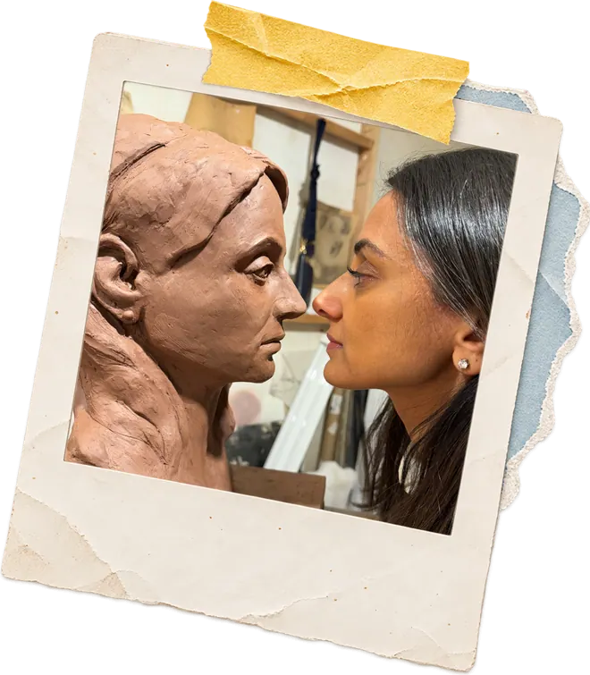Zainab face to face with a clay portrait bust she is sculpting.