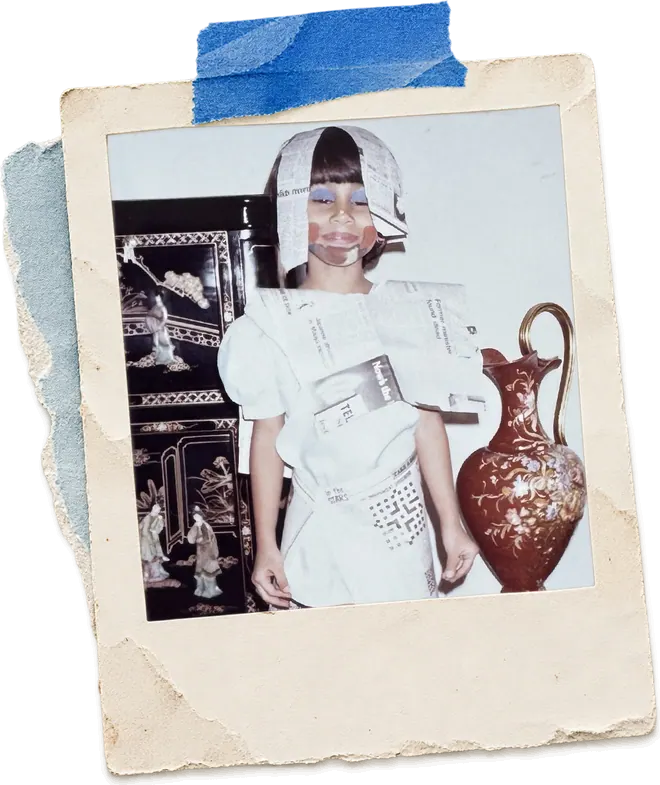 Zainab as a child in a costume made entirely of newspaper.