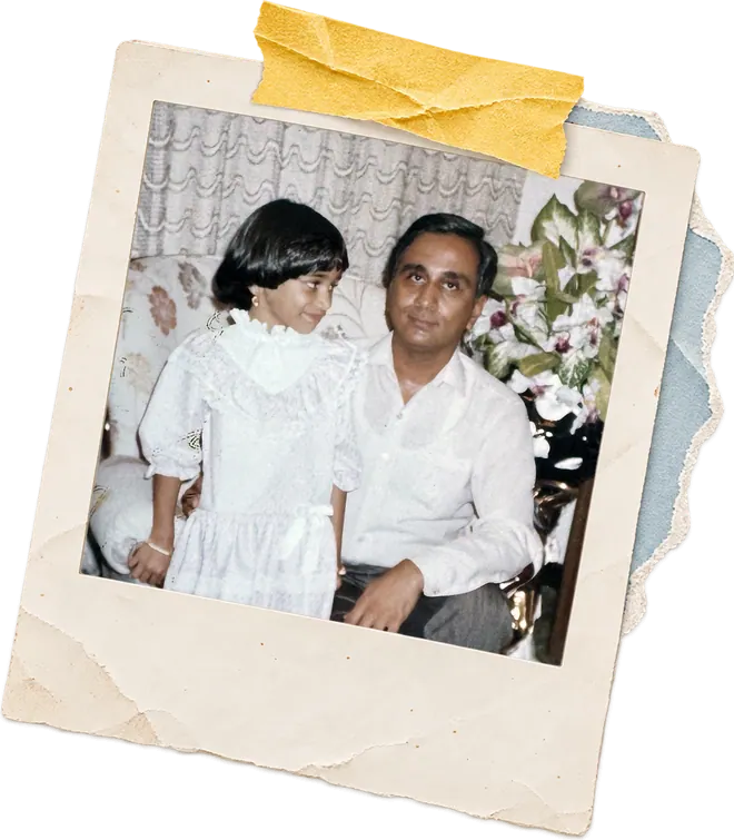 Zainab as a young girl sitting with her father.